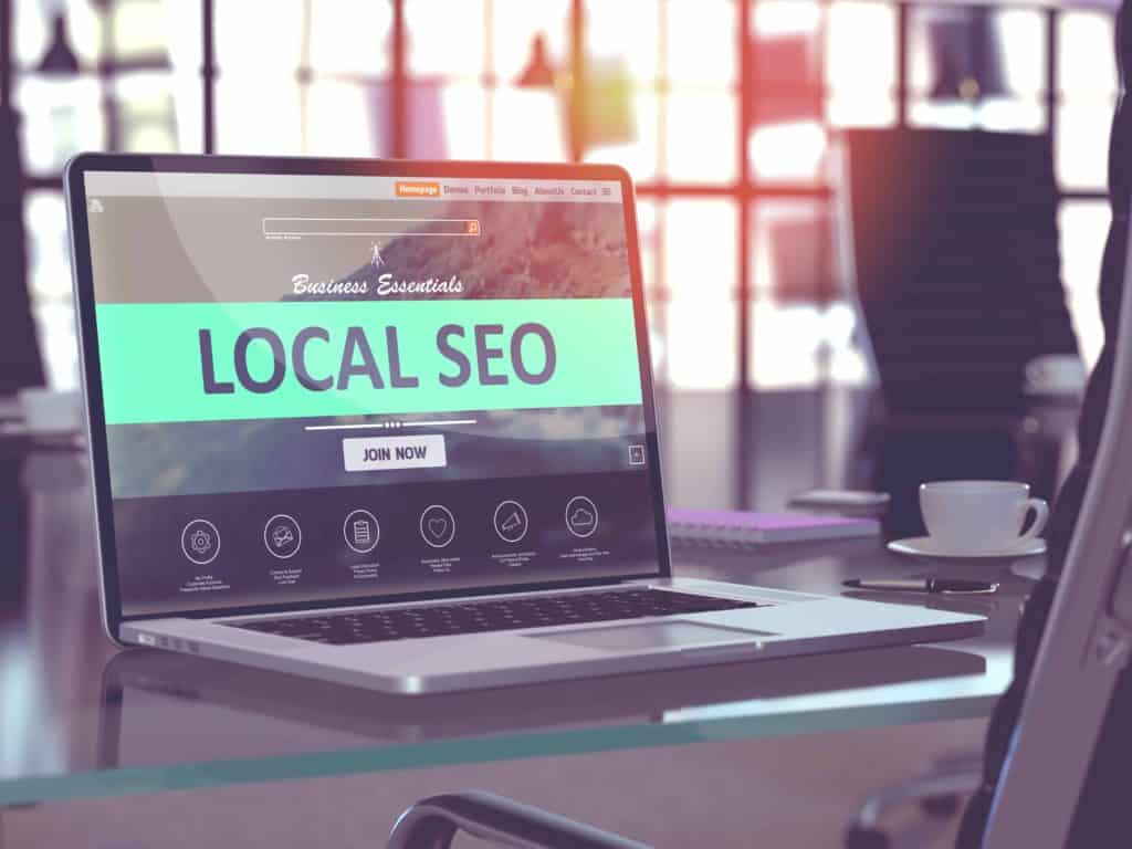 A laptop that says "local SEO" on the screen